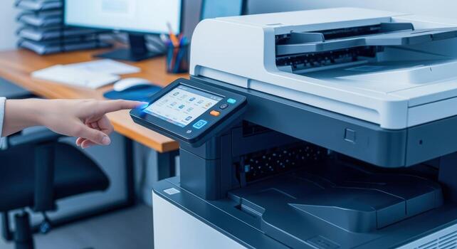 Person operating a modern multifunction printer in office environment for document management and workflow efficiency photo