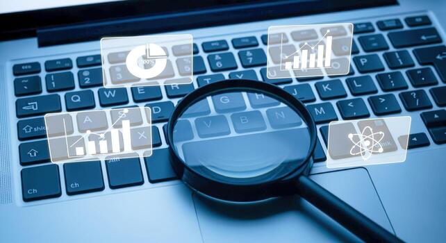 Analyzing Business Data on a Laptop with a Magnifying Glass and Data Graphics Overlay photo