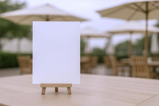Blank White Menu Card Mockup on Wooden Easel Displayed on Restaurant Table with Blurry Background photo