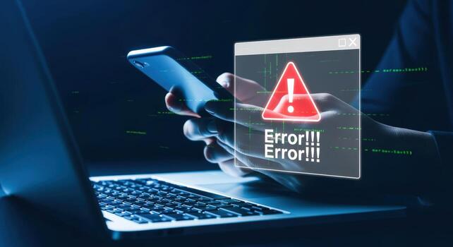 Digital Error Message on Screen User Holding Phone with Laptop Showing Alert photo