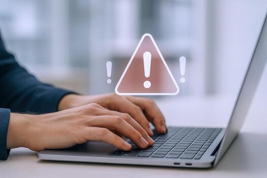 Person Typing on Laptop with Warning Sign Overlay Cybersecurity, Data Breach, and System Error Concept photo