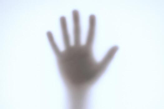 Blurred Silhouette of a Hand Reaching Out, Abstract Image Conveying Mystery, Isolation, or a Plea for Help photo