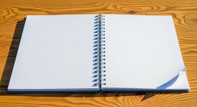 Open Spiral Notebook with Blank Pages on Wooden Desk Ready for Writing or Sketching photo