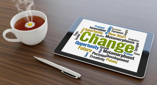 Digital Transformation Concept Displayed on Tablet Next to Tea Cup and Pen on Wooden Table photo