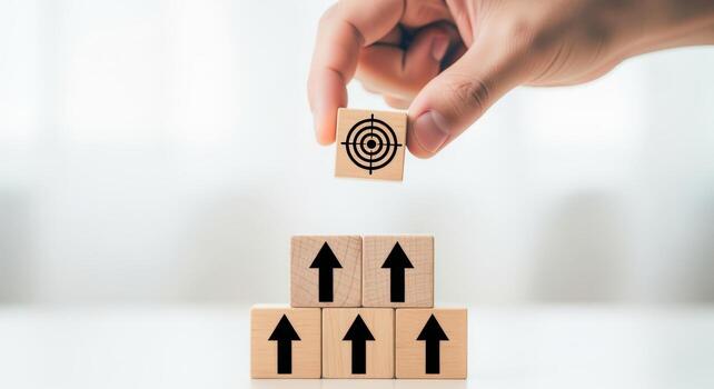 Achieving Business Goals Hand Placing Target Block Atop Arrow Blocks, Symbolizing Success and Growth photo