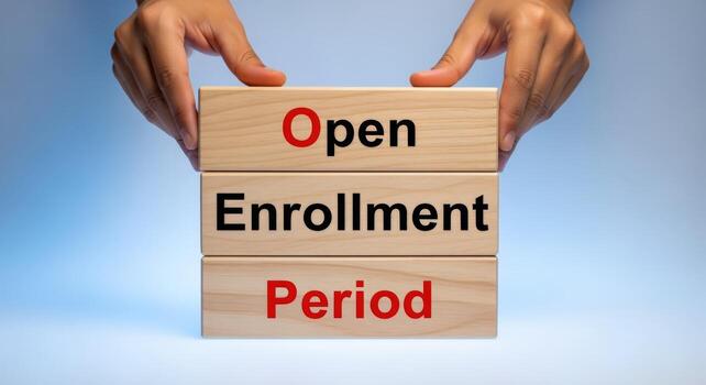 Open Enrollment Period Concept Hands Holding Wooden Blocks with Text on a Gradient Background photo