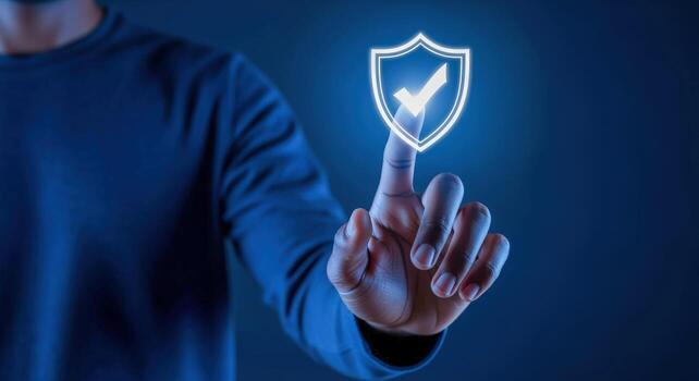 Cybersecurity Concept Man Touches Glowing Shield with Checkmark, Ensuring Digital Data Protection and Privacy photo
