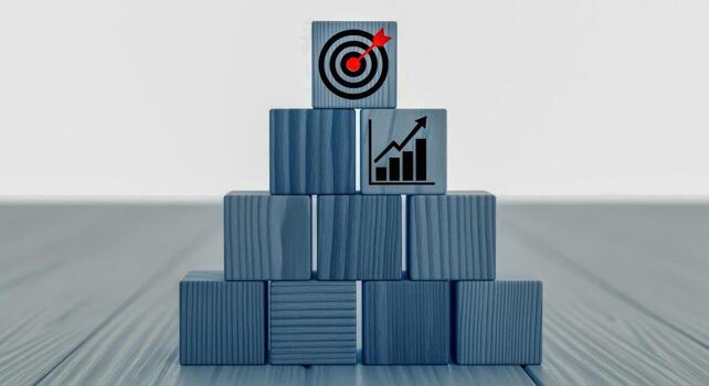 Achievement of business goals demonstrated by wooden blocks stacked as a pyramid, representing strategy and growth photo