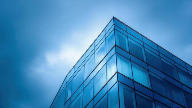 Modern Glass Building Corner with Blue Sky Architecture, Design, and Sustainable Urban Development photo