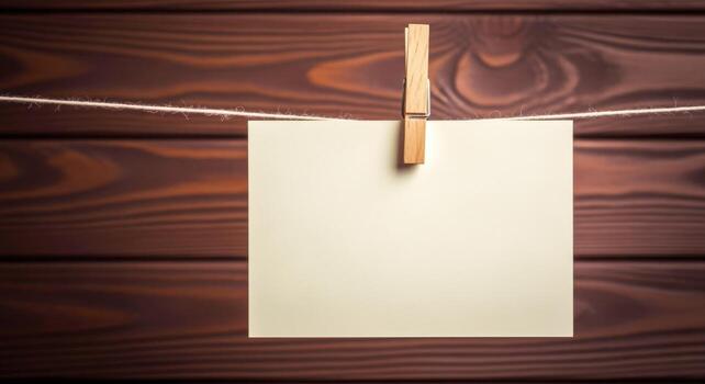Blank Card Hanging on Wooden Background with Clothespin, Perfect for Adding Your Message photo