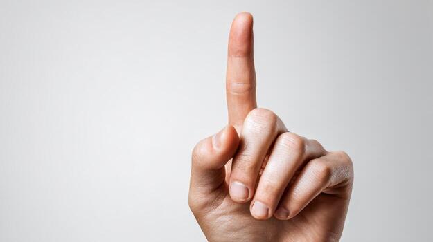 Hand Gesturing Upward with Index Finger Raised on White Backdrop for Conceptual Representation and Instruction photo