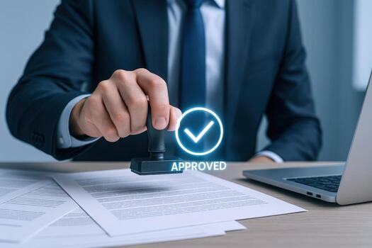 Business Professional Approving Documents with a Stamp of Approval for Final Authorization and Confirmation photo