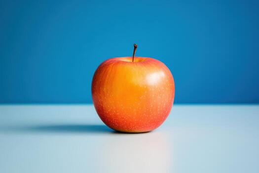 An apple on a blue background photo