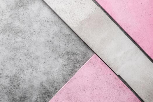 A pink and gray background with a triangle shape photo