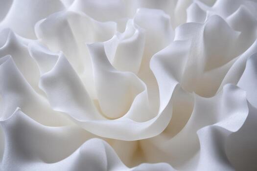 Soft white fabric creating elegant wave patterns in natural light photo