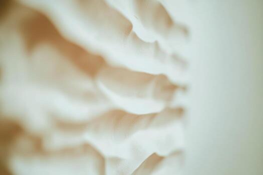 Soft light creates shadows of hands on a textured surface in a serene setting photo