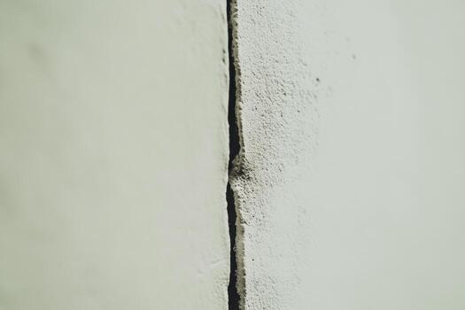 Crack formation in concrete wall reveals structural issues in building photo