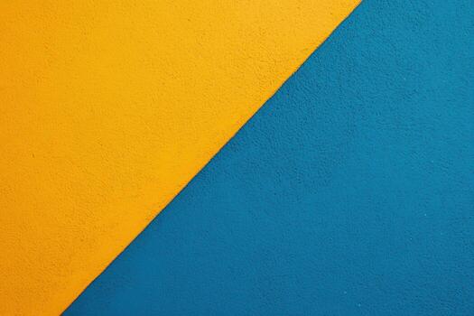 Bright yellow and blue color block design on textured wall surface photo
