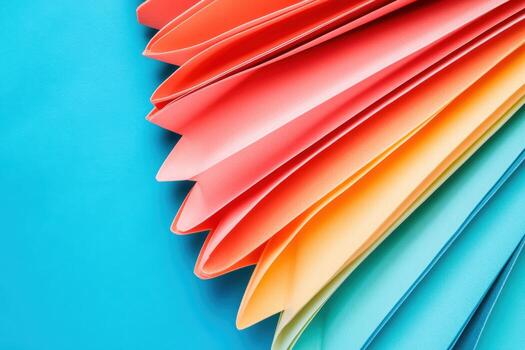 Colorful paper folds create vibrant patterns on a blue background photo