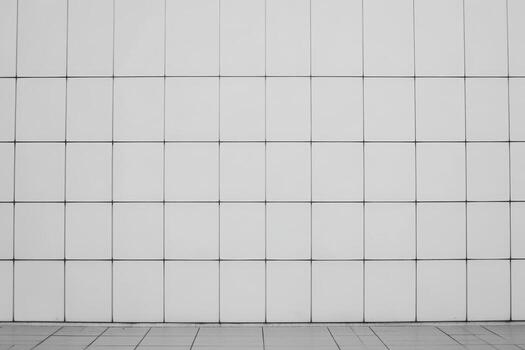 Minimalist white tiled wall design with grid pattern in an urban setting photo