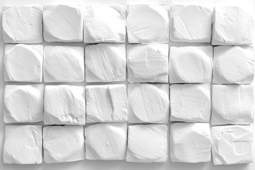 blanco texturizado cubitos arreglado en un cuadrícula modelo en un suave superficie foto