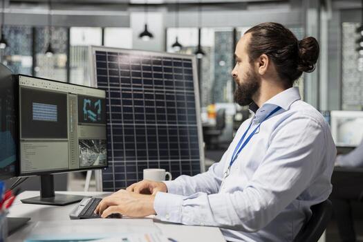 Engineer working for green tech company uses CAD program to optimize sustainable solar panel fabrication with advanced assembly lines. Clean energy professional innovates solar manufacturing processes photo