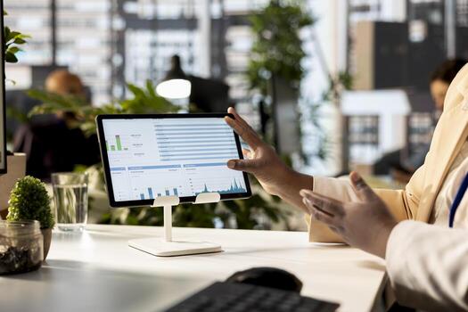 African american executive team are engaged in administrative tasks, reviewing progress reports and using data to ensure alignment with company objectives. Business management. Close up. photo