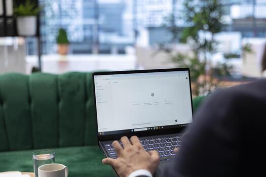 Bucharest, Romania - July 30th 2024 - Man uses futuristic AI chat on software to enhance productivity and efficiency in business operations. Chatgpt AI tool bot generating text. photo