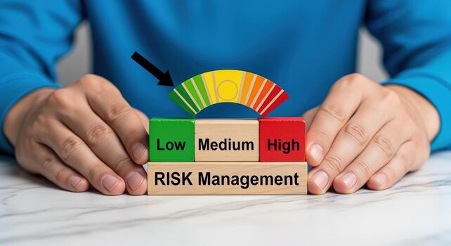 Risk Management Blocks Showing Low, Medium and High Risk Levels with Gauge, Indicating Low Risk photo