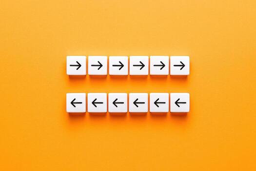 Directional Cues with Arrows on Tiles, Isolated on Orange Background, Symbolizing Contrasting Perspectives and Opposite Approaches photo