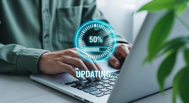 Software Update Progress on Laptop with Person Typing Shows Halfway Complete photo