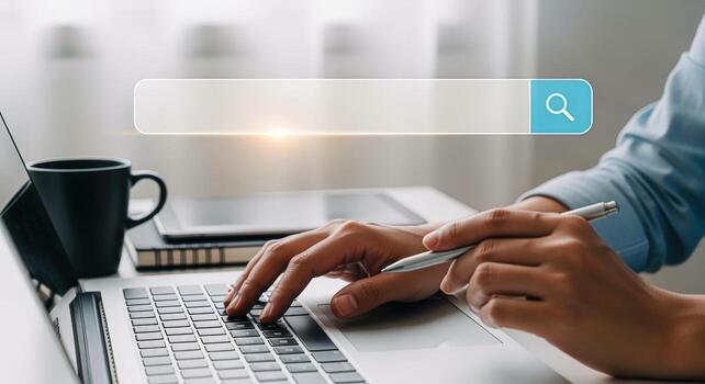 Hands Typing on Laptop with Search Bar Overlay for Online Searching Concept photo