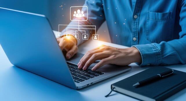 Business professional working on laptop illustrating organizational structure, hierarchy, and leadership development for employee management photo