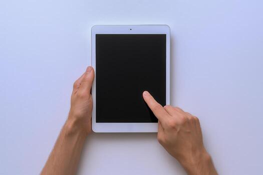 Hands holding and touching a tablet with blank black screen for mockup on white background photo