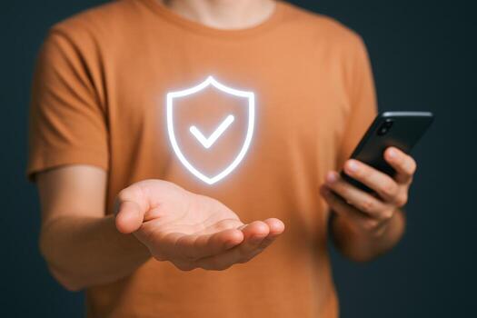 Mobile Security Person Holding Phone with Shield Graphic, Digital Protection and Secure Technology Concept photo
