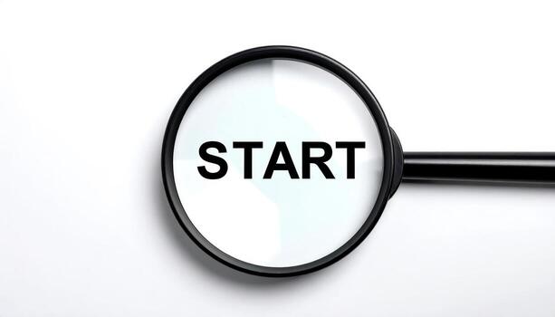 Magnifying Glass Focusing on the Word START on a White Background Symbolizing Beginning of New Journey or Project in Business or Education photo