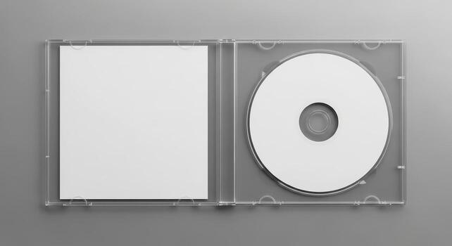 Overhead flat lay of an open transparent plastic case containing a blank white compact disc and a square paper booklet, ideal for music or data mockup on a gray background photo