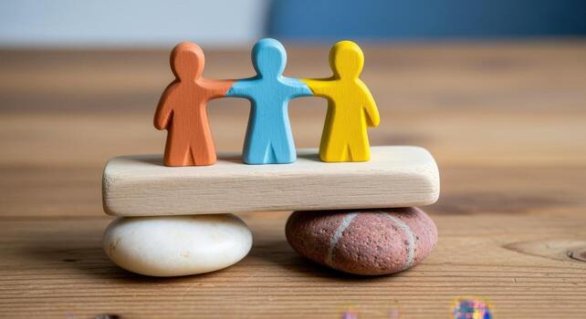 Conceptual Image of Unity Three Wooden Figures Standing Together on Stones and a Wooden Block photo
