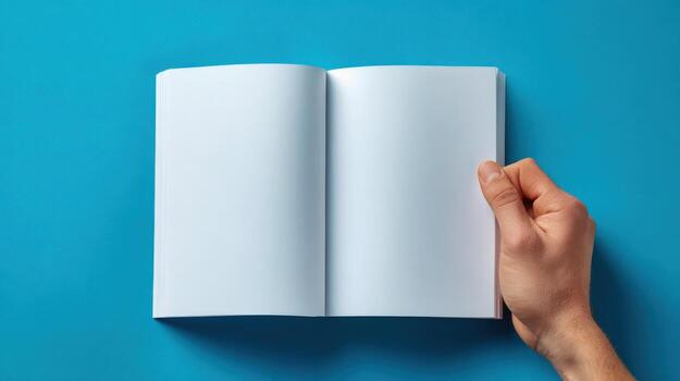 Open Blank Book Mockup with Hand on Blue Background for Design Template, Branding photo