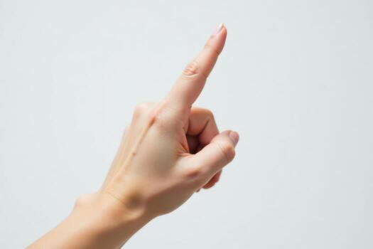 A person's hand pointing up on a white background photo