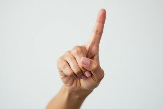 A person holding up a finger with a white background photo