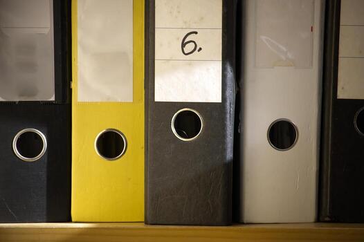 The image shows a close-up of several ring binder folders, neatly arranged and ready for use. photo
