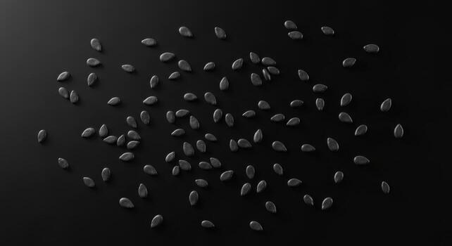 Top view of black sesame seeds scattered on a dark background with copy space photo