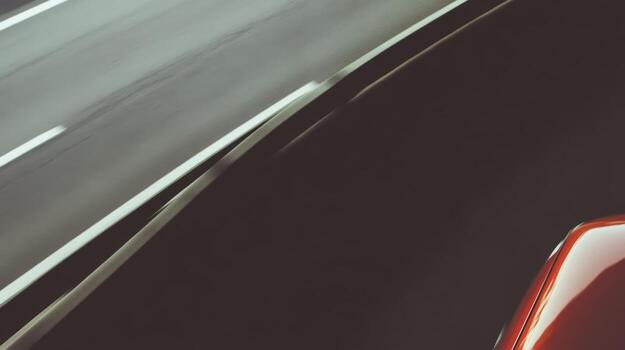 Fast car speeding on an empty highway during daylight photo