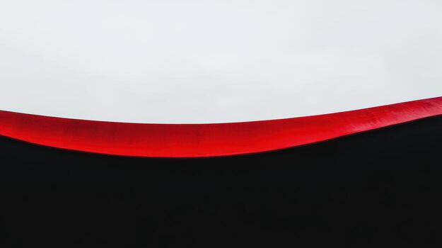 Vibrant contrast of red and black under a cloudy sky at dusk photo