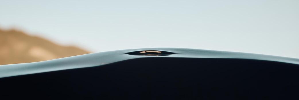 Mysterious object shimmering on a dark surface against a tranquil backdrop photo