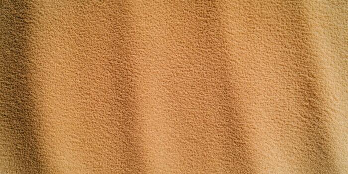 Texture of soft fabric draped elegantly on a warm backdrop photo