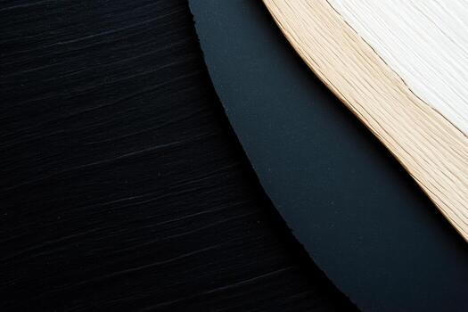 Textured layers of paper and cardstock arranged on a dark surface photo