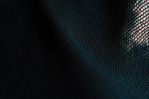 Textured dark fabric showcasing intricate mesh pattern in close detail photo