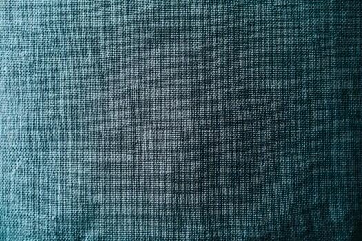 Textured fabric in deep teal color showcasing intricate weave patterns photo